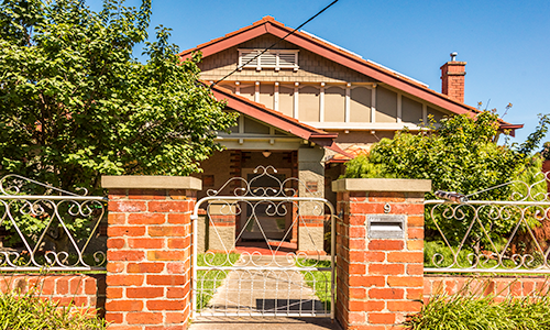 Brunswick style woven wire gate on brick frence